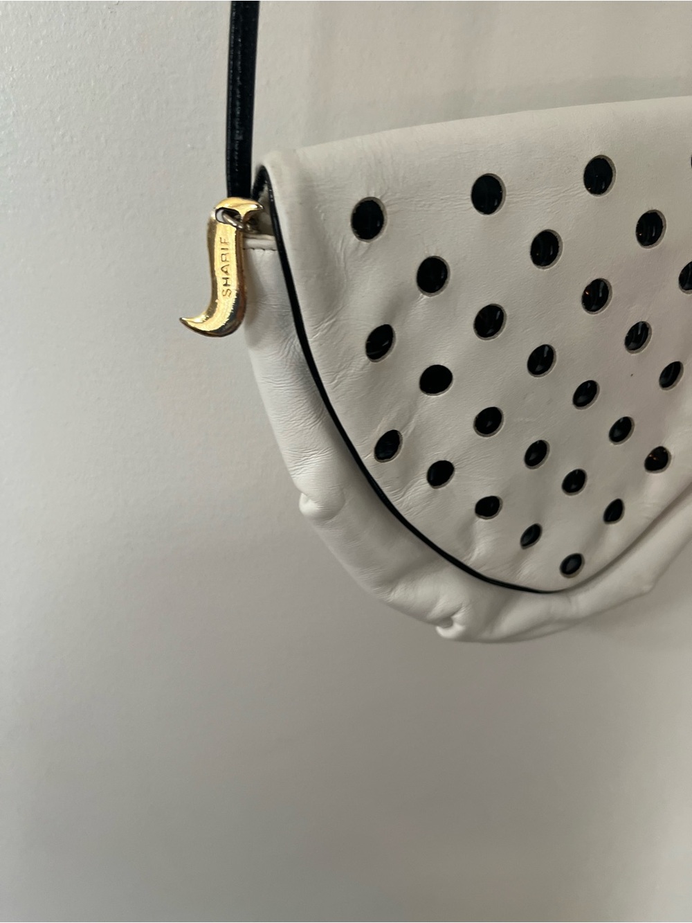 Sharif White Crossbody with Black Perforated Accents and Gold Charm